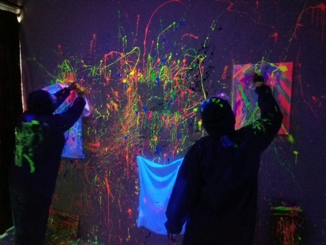 Group of friends having fun at our splatter paint room in Jupiter, FL