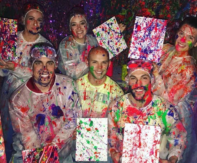 Group photo after a fun night a splatter paint party held by uptown paint and sip in Jupiter FL the perfect idea for a girls night out, date night, or team building